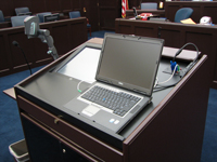 Picture of a laptop sitting on the podium open and ready for use